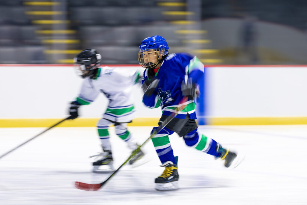 Action shot kids playing hockey