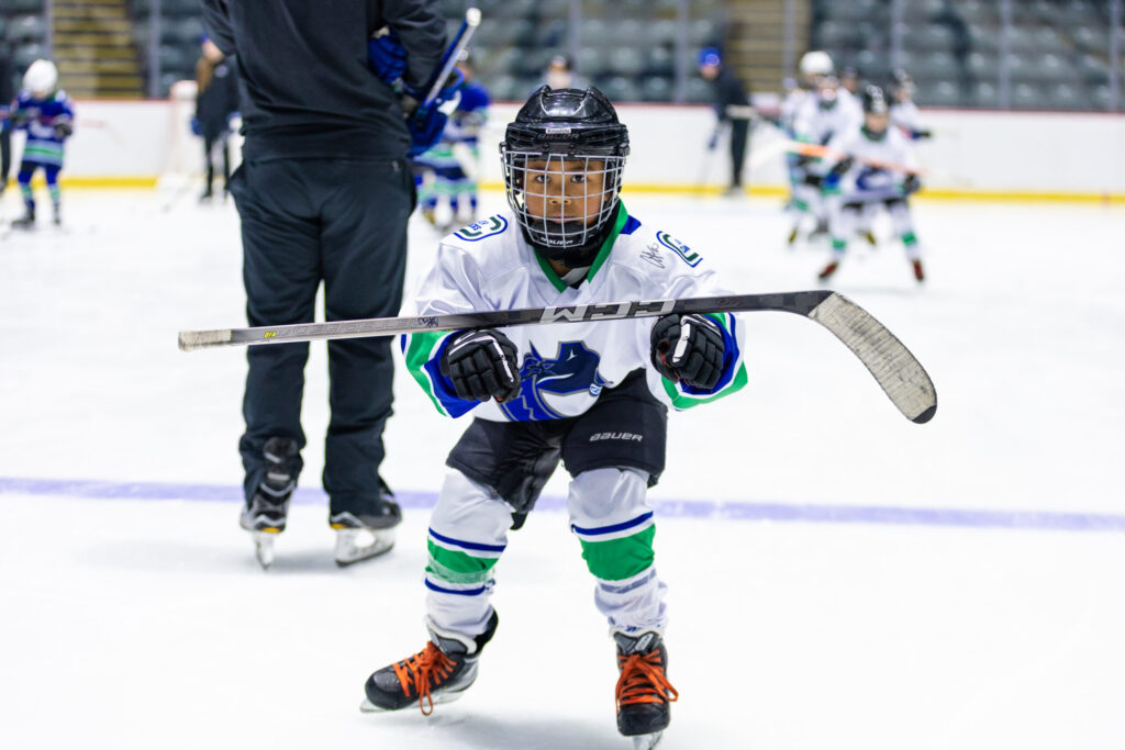 Young kid skating in Canucks gear