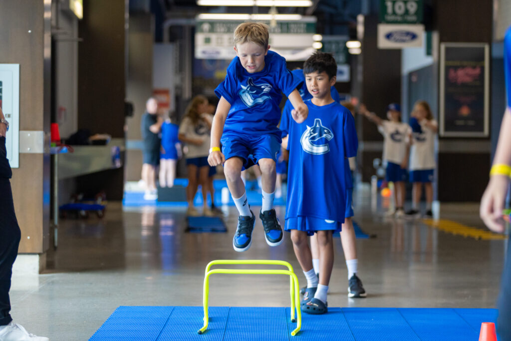 Kids doing hurdle jumps