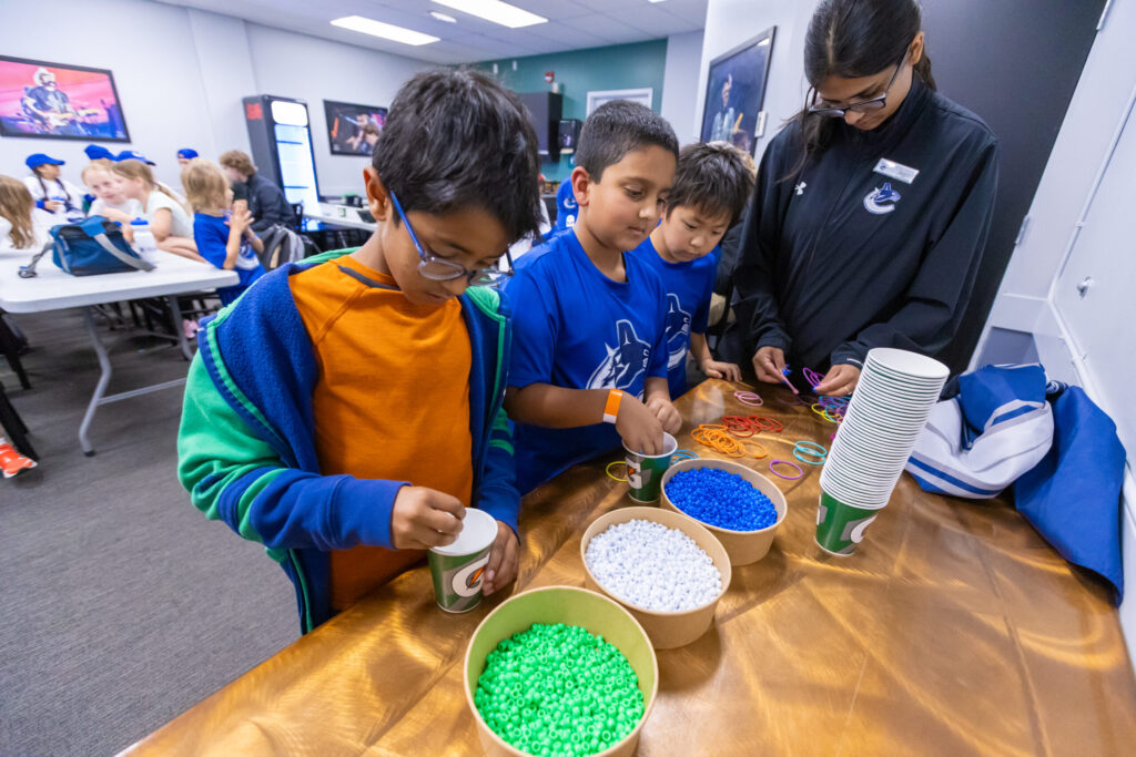 Kids making friendship bracelets